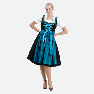 Woman wearing a black and turquoise traditional Dirndl dress with white puff-sleeve blouse and satin apron for Oktoberfest