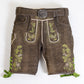 brown lederhosen with green embroidered deer and vine patterns, decorative front flap, and matching stag buckle belt