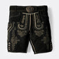 Black suede lederhosen with intricate charcoal embroidery, decorative side buttons and traditional silver-tone buckle belt