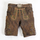 Brown suede lederhosen with green embroidered detailing, decorative side buttons and vintage silver buckle belt