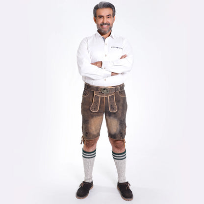 Brown suede lederhosen with dark floral embroidery, contrast piping and antique deer buckle belt