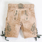 White suede lederhosen with green oak leaf embroidery, side lace ties and decorative silver-tone buckle belt