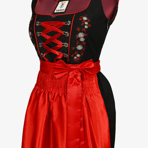 Black dirndl dress with vibrant red apron, floral embroidery, ribbon lacing, perfect for Oktoberfest, Bavarian festivals, traditional celebrations, and cultural events
