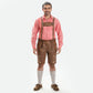 Traditional Oktoberfest outfit with light brown lederhosen, matching suspenders, a red and white checkered Trachten shirt, gray knee-high socks, and brown Haferl shoes.