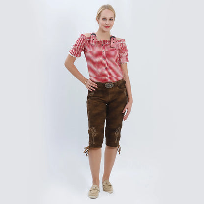 Brown suede knee-length women lederhosen with cream floral embroidery, side lace details, and a decorative stag buckle belt