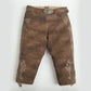 Brown suede knee-length women lederhosen with cream floral embroidery, side lace details, and a decorative stag buckle belt